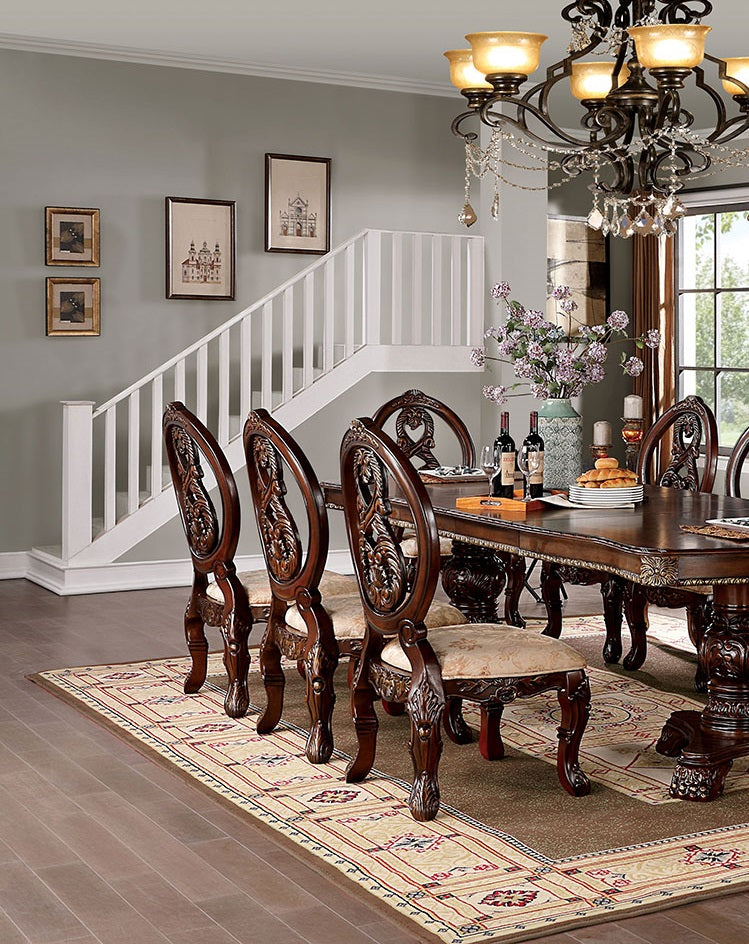 Ornate dark wood dining chairs with upholstered seats and intricate carvings
