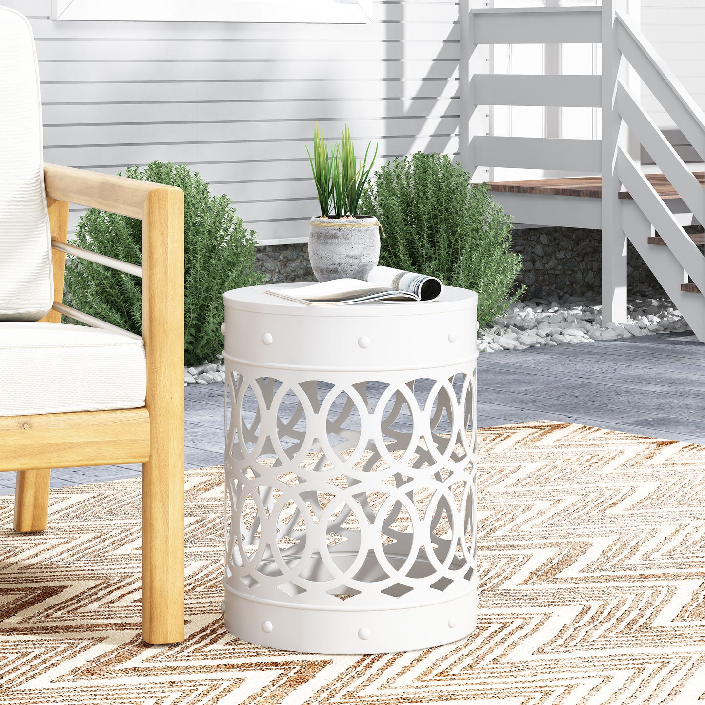 White metal garden stool with openwork design perfect for outdoor seating areas