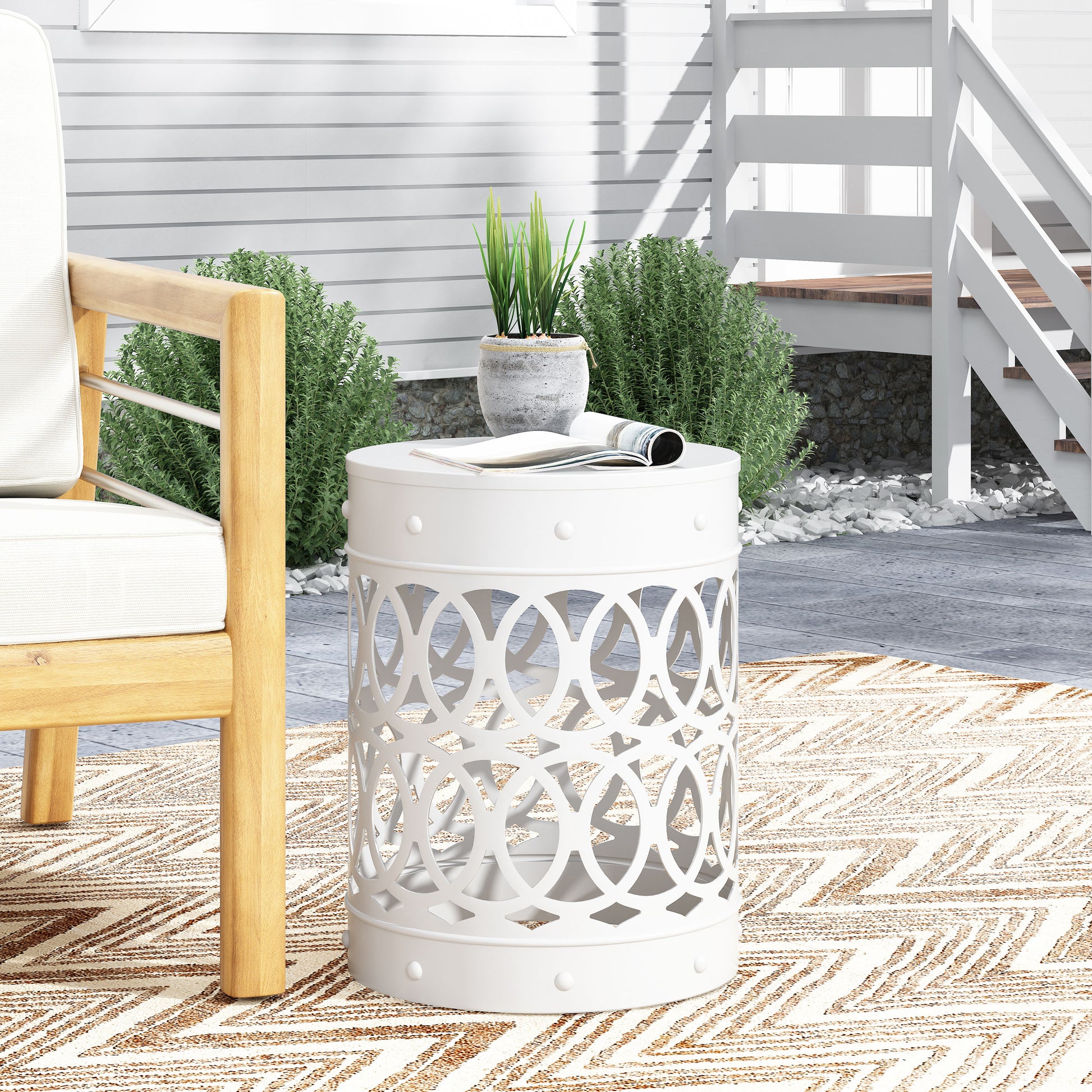 White metal garden stool with openwork design perfect for outdoor seating areas