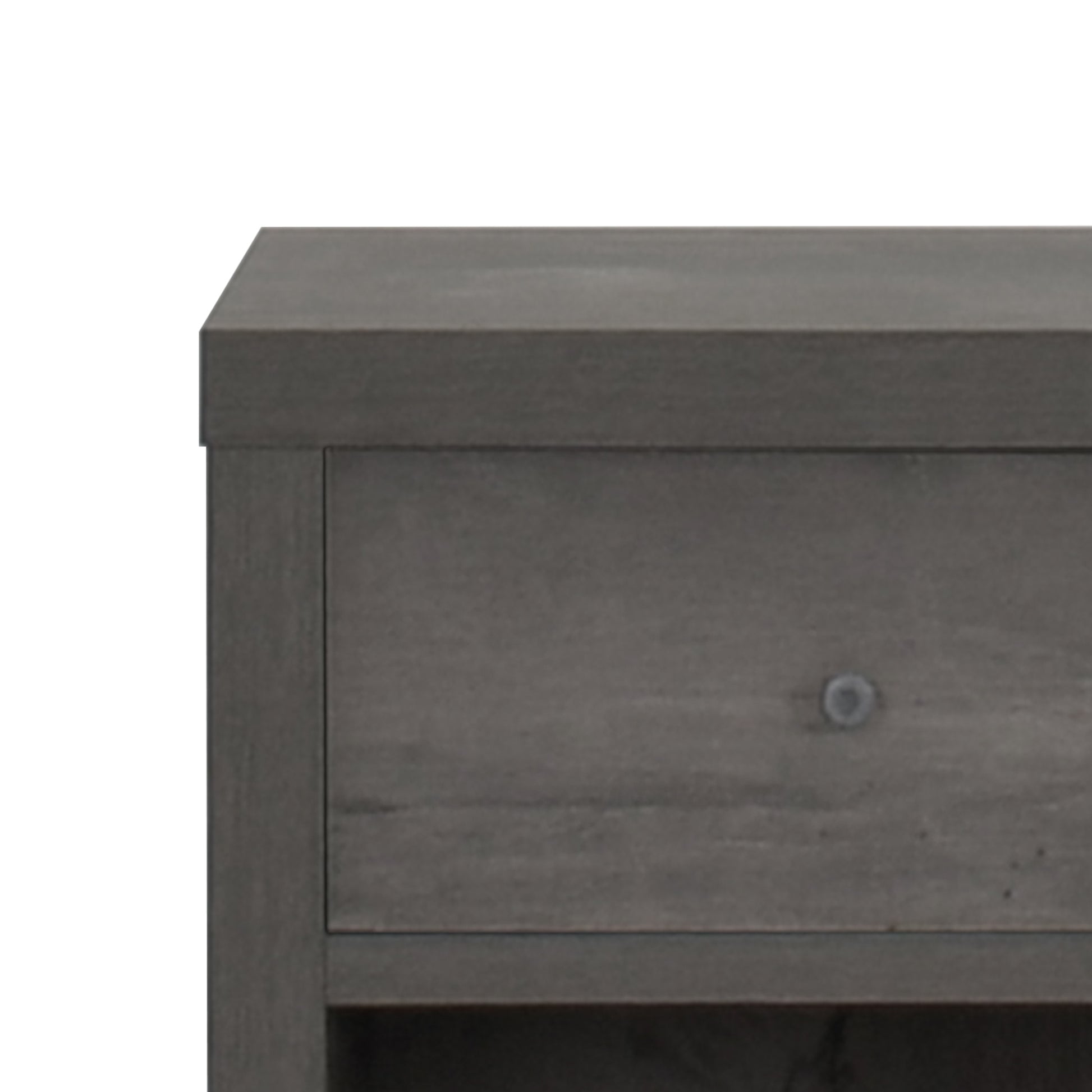Closeup of dark gray wood grain dresser drawer with a brushed nickel knob