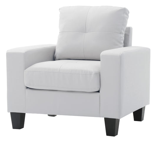 White leather armchair with square tufted cushions and black wooden legs