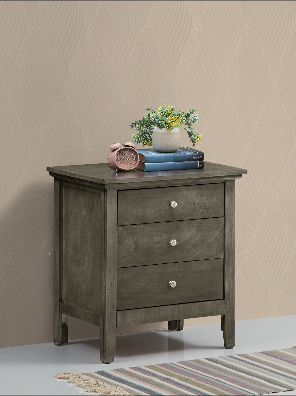 Grey wood threedrawer nightstand with silver knobs and decorative accents on top
