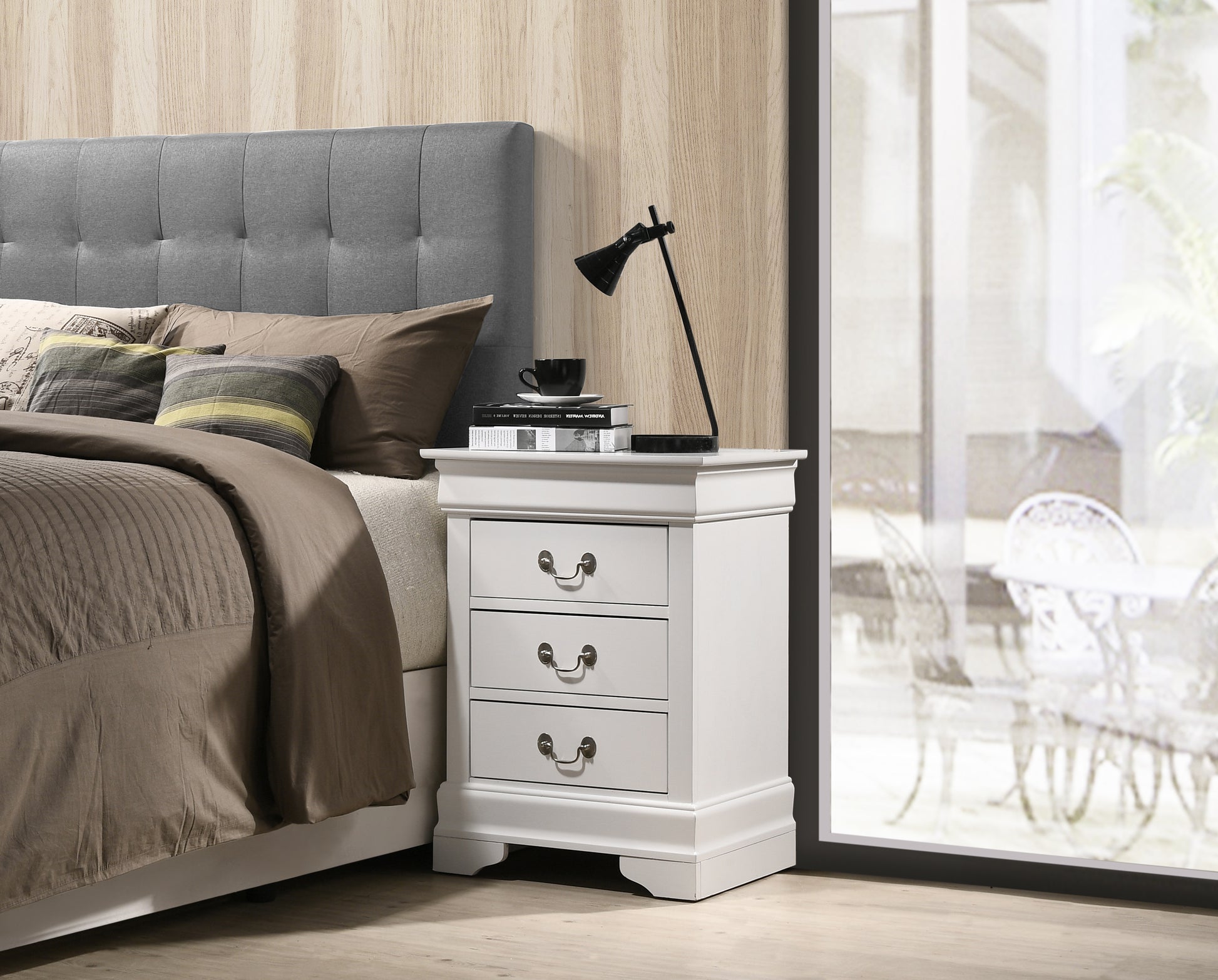 White threedrawer nightstand with ornate hardware and decorative molding
