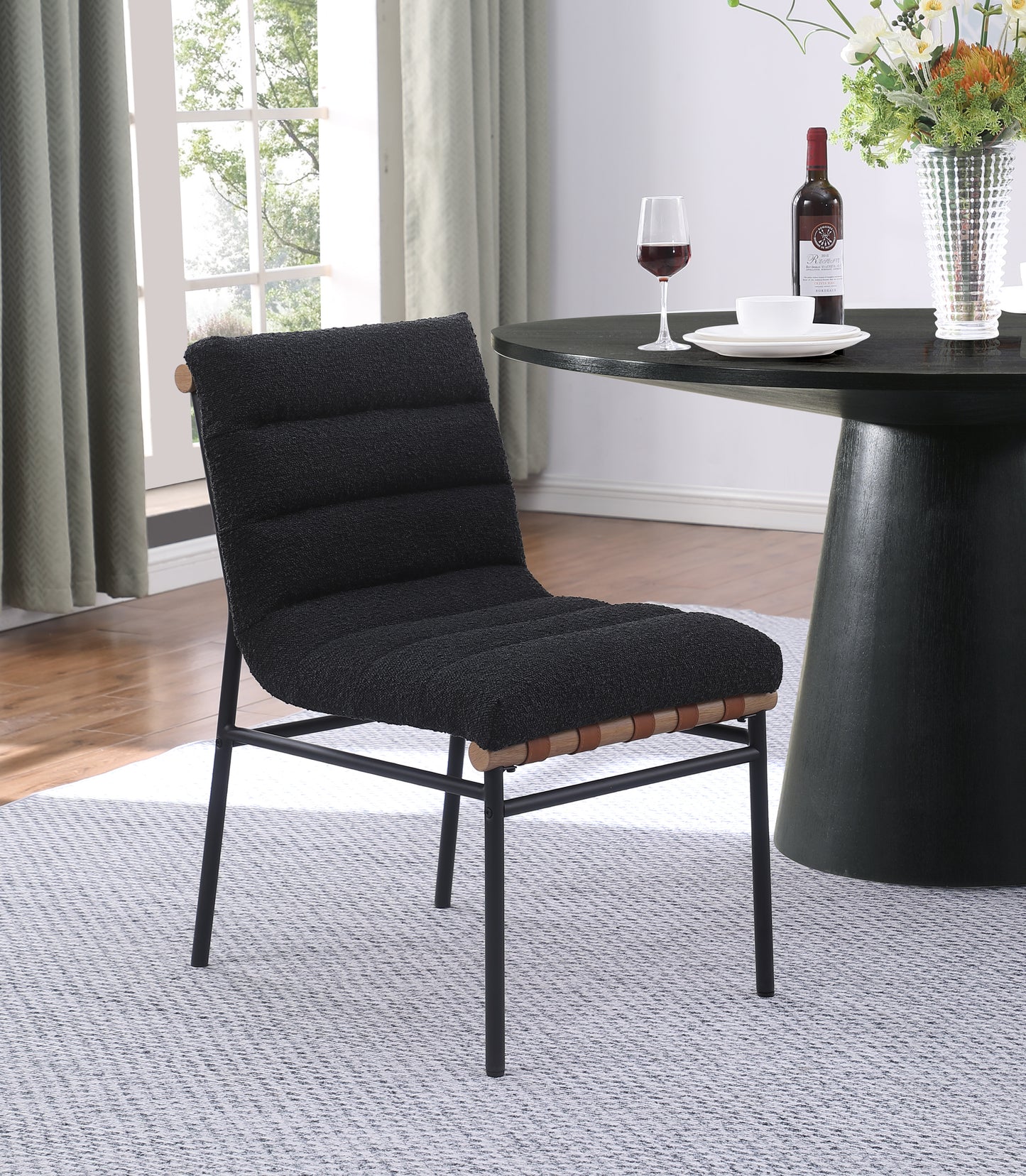 Black boucle accent chair with black metal legs and wood details