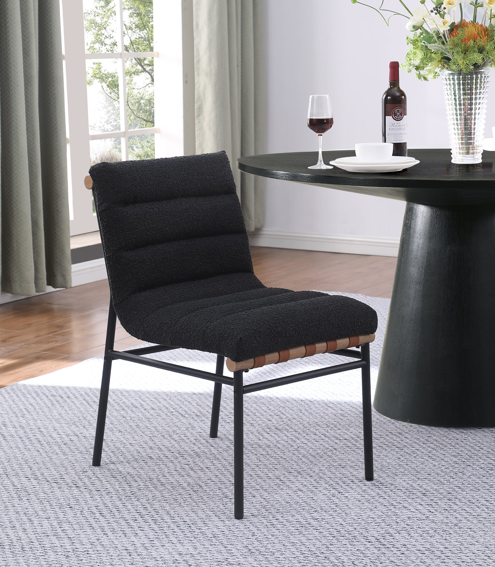 Black boucle accent chair with black metal legs and wood details
