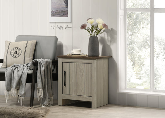 Grey upholstered armchair with decorative pillow and grey throw blanket