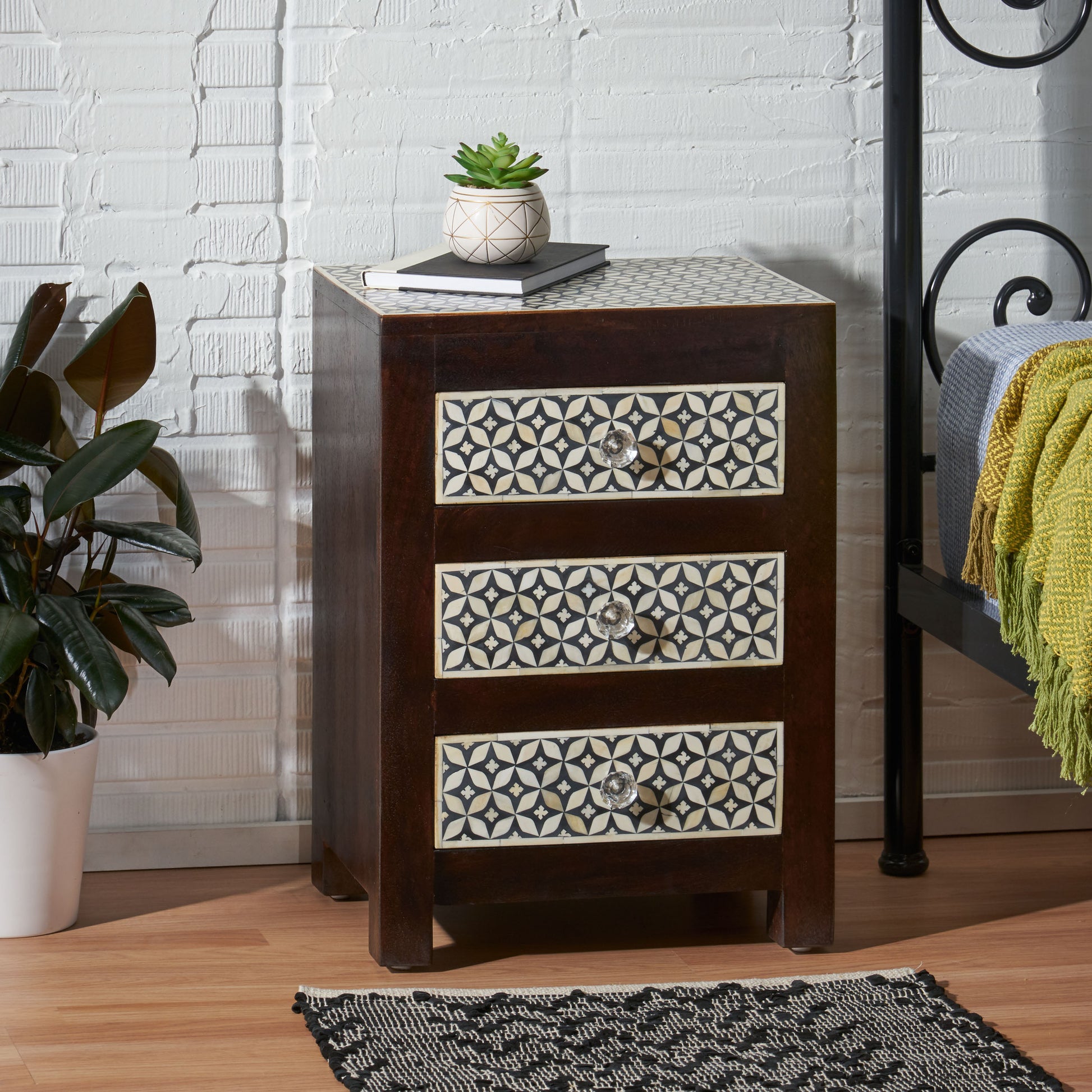 Dark wood bedside table with three drawers featuring bone inlay geometric pattern