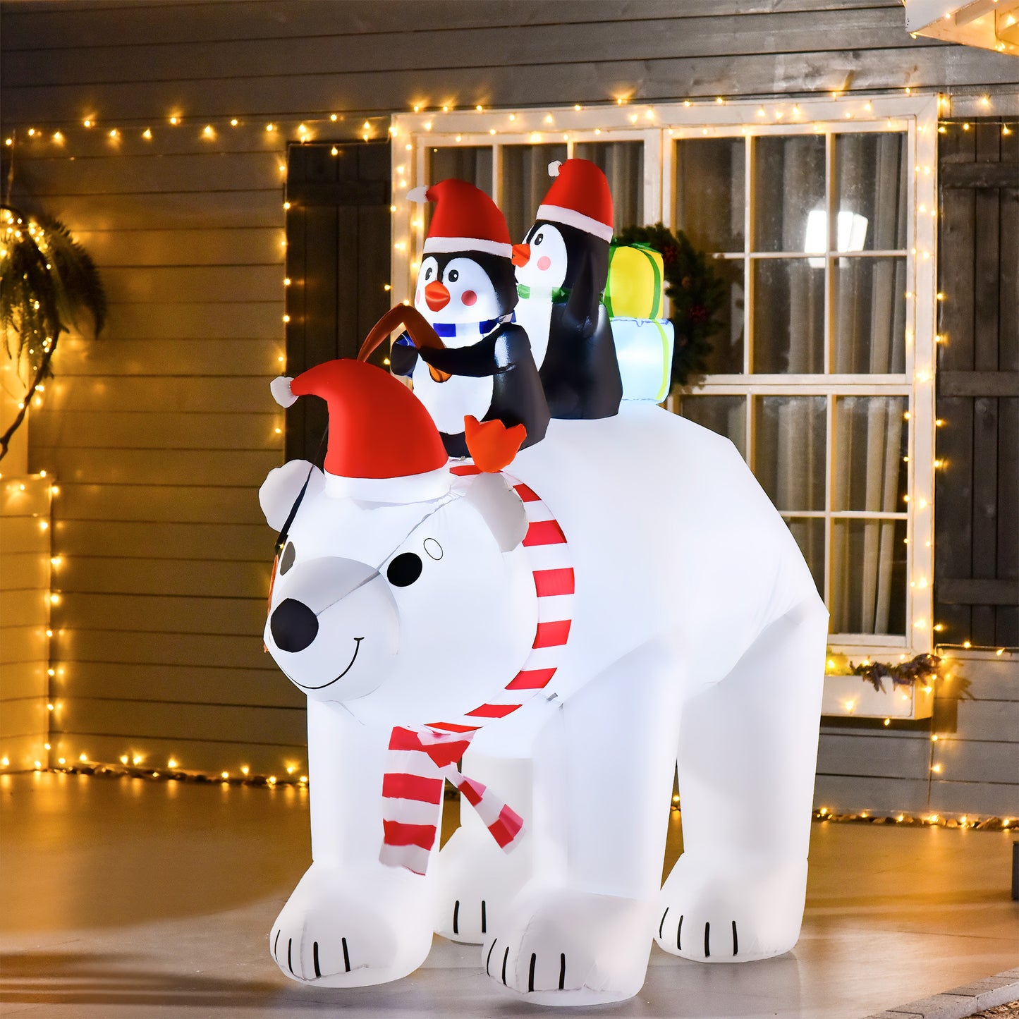 White inflatable polar bear with penguins and gifts for Christmas yard decoration