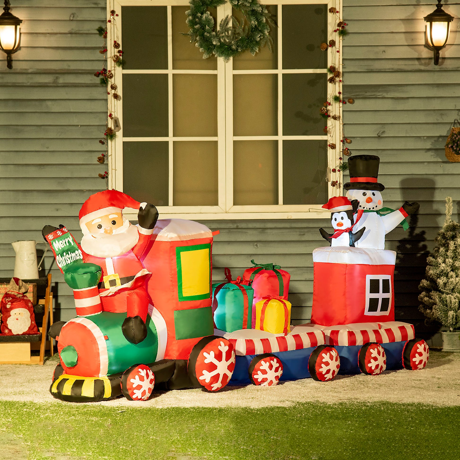 Inflatable Santa train with penguin and snowman holiday decoration perfect for outdoor Christmas displays