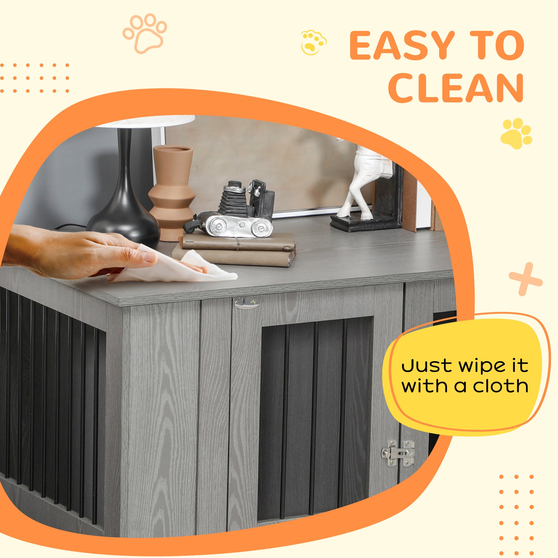 Wooden dog crate in grey wood grain finish being wiped clean with a cloth easy to maintain