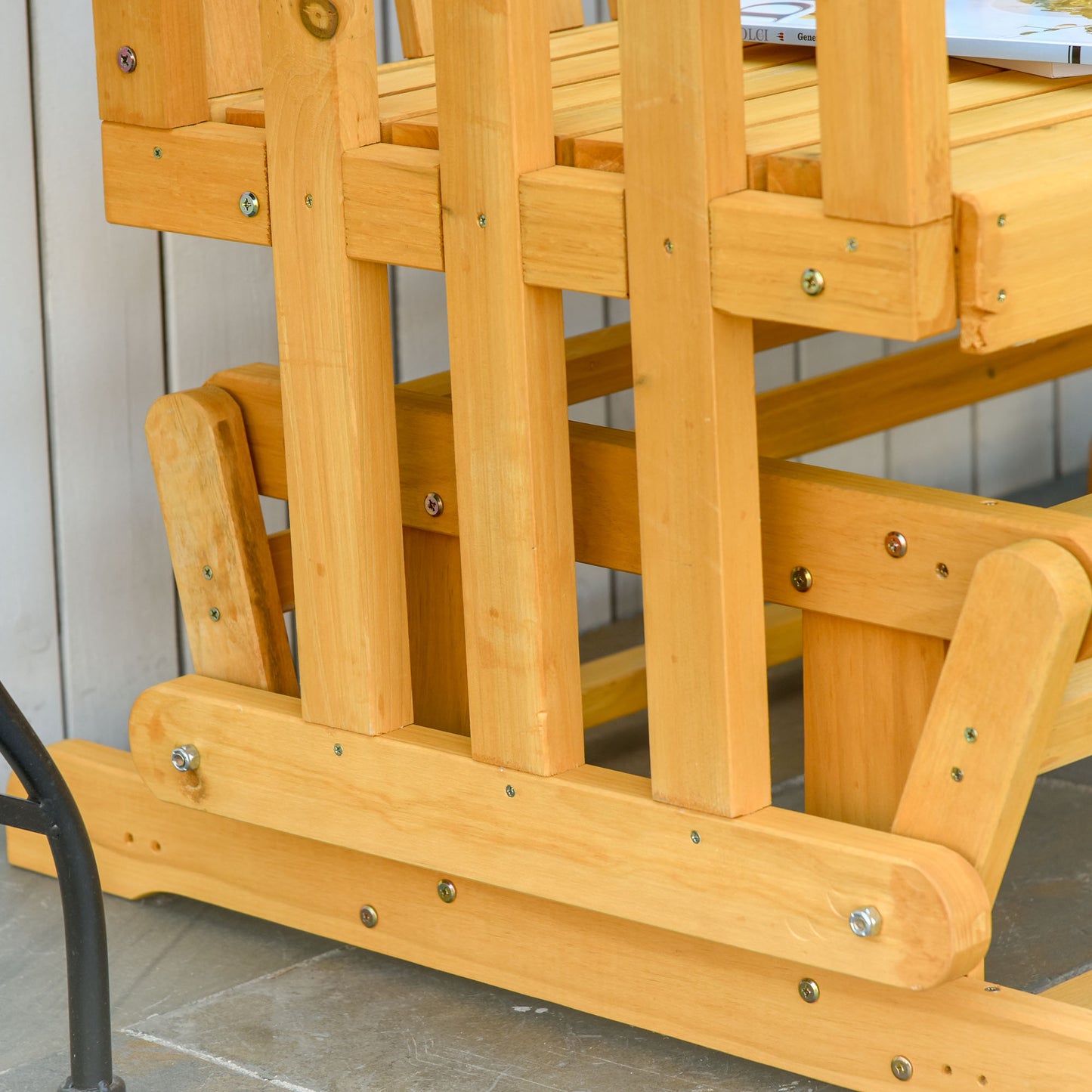Natural wood glider bench construction detail with visible screws