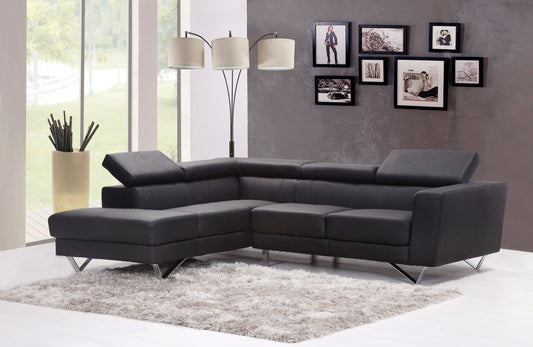 Dark gray leather sectional sofa with chrome legs on a plush rug