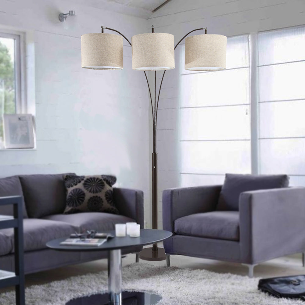 Arched floor lamp with three linen shades in beige illuminating living spaces