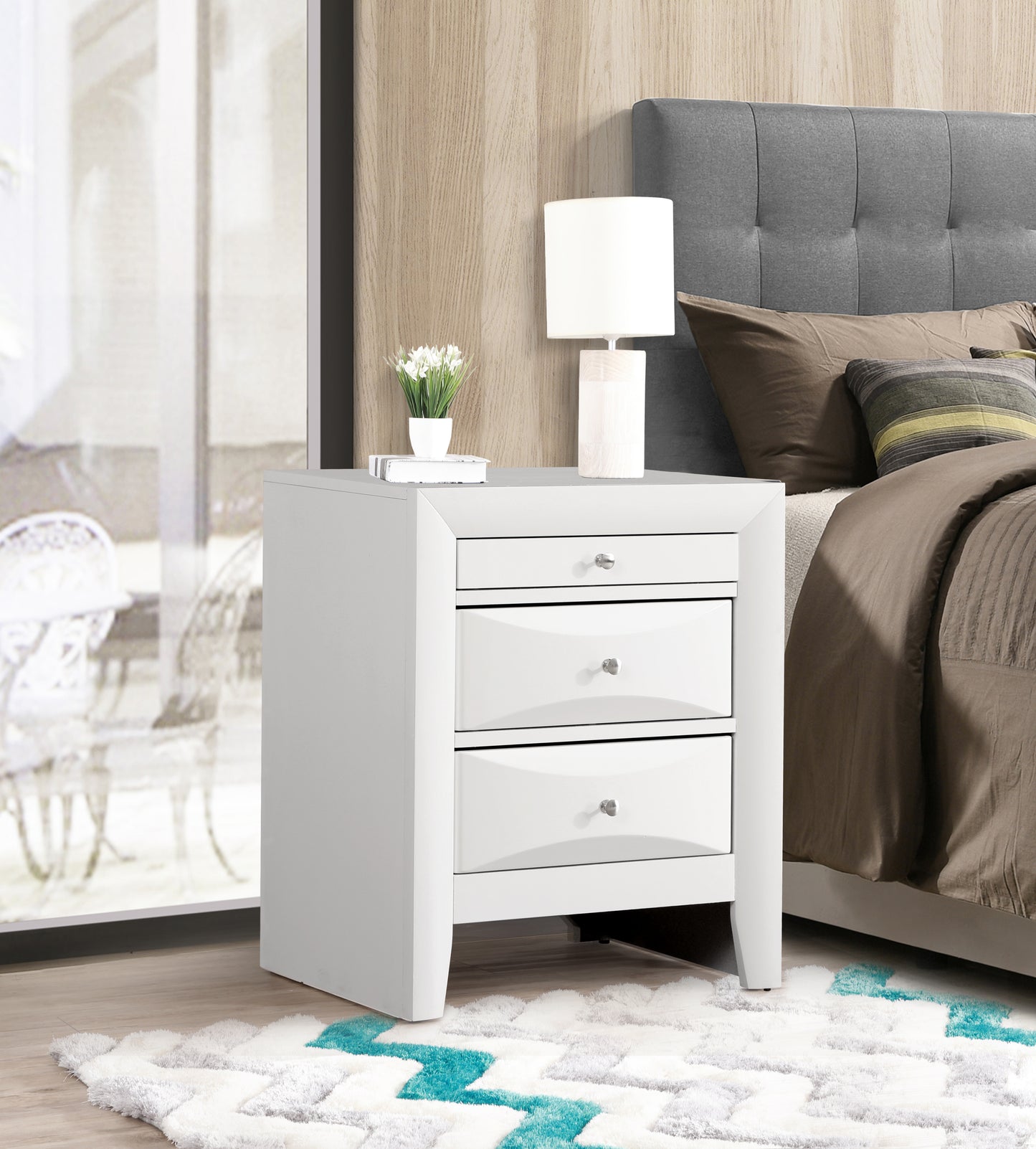 Sleek white threedrawer nightstand with silver knobs perfect for modern bedrooms