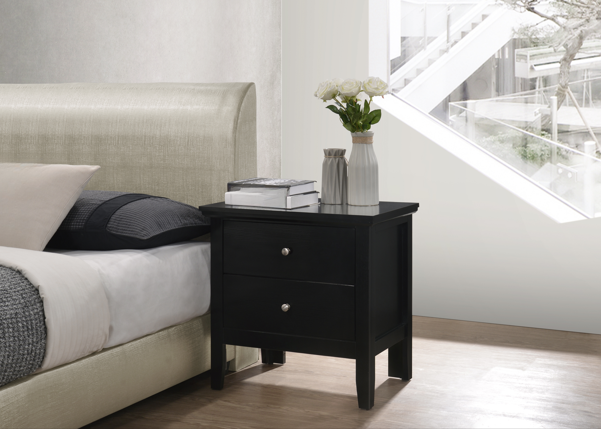 Black twodrawer nightstand with silver knobs on a wooden floor