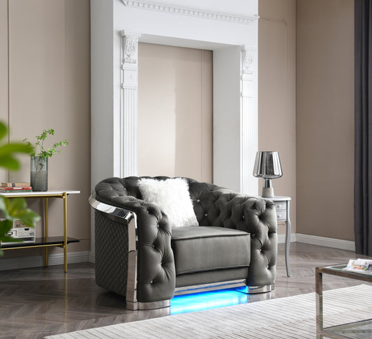 Luxurious gray velvet armchair with tufted detailing and crystal accents