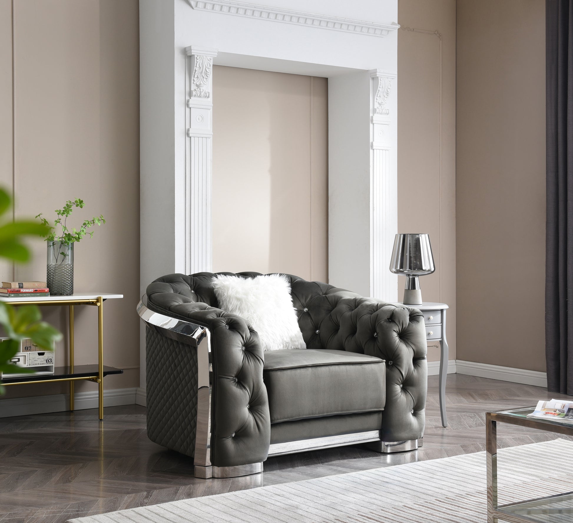 Dark grey velvet armchair with tufted design and chrome accents