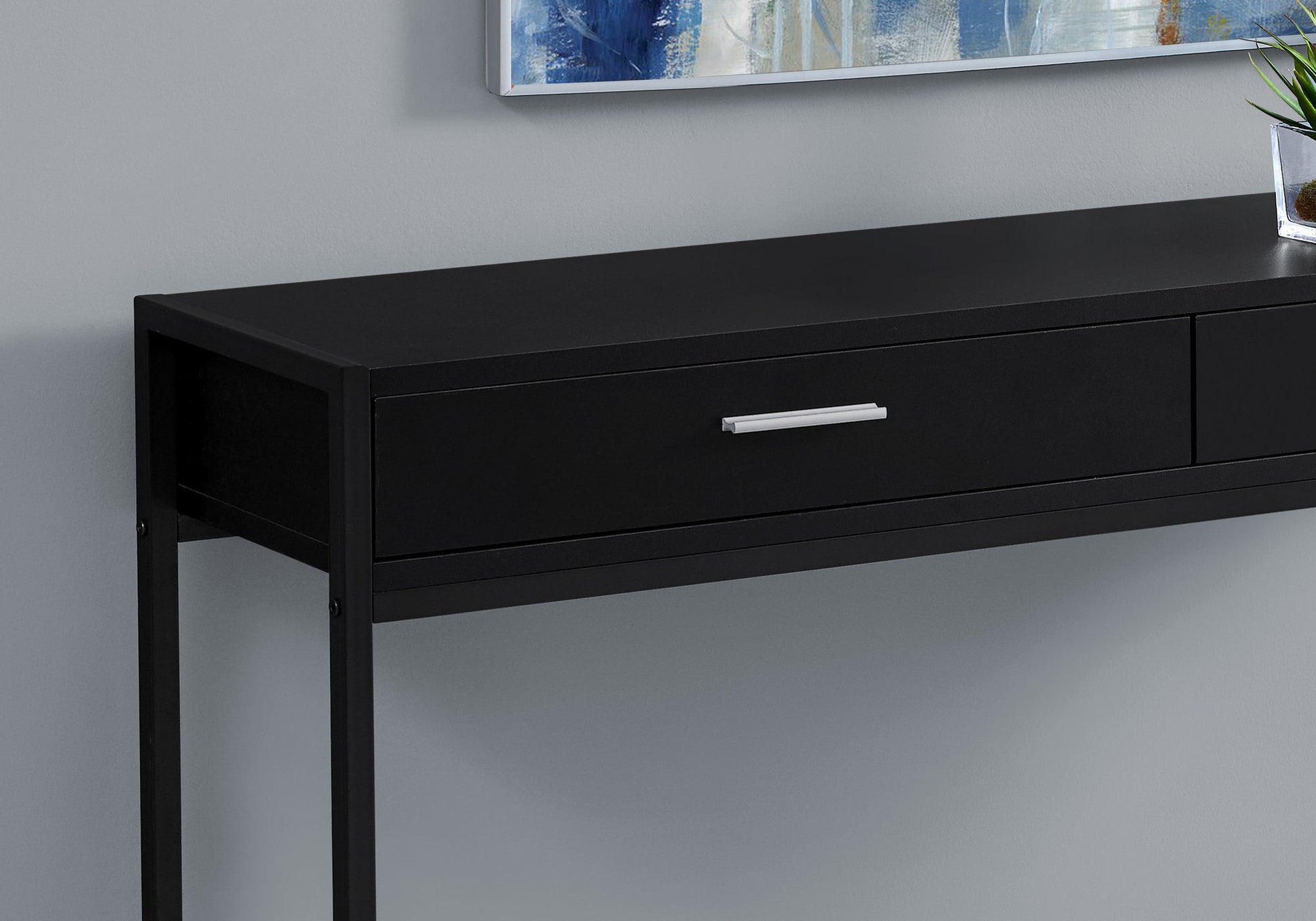Sleek black entryway console table with a single drawer and silver handle