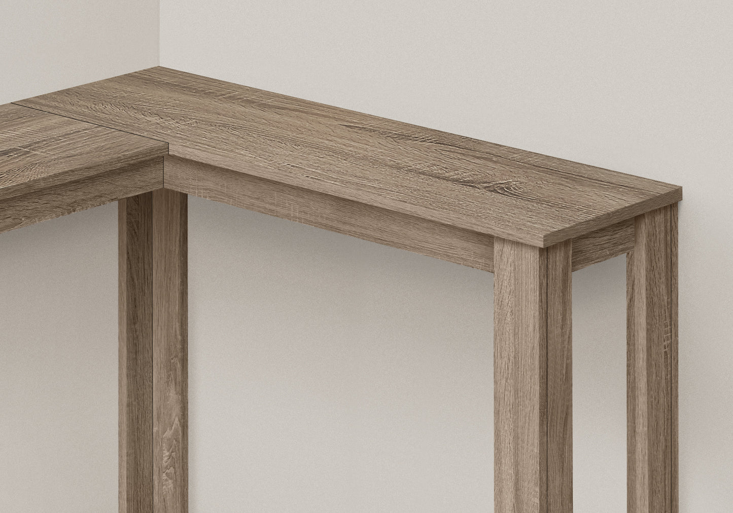 Corner desk surface in light oak laminate with visible wood grain texture