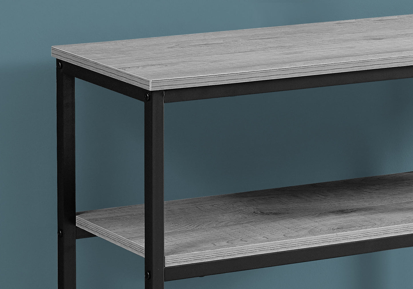 Closeup of a rustic gray wood bookshelf with black metal frame