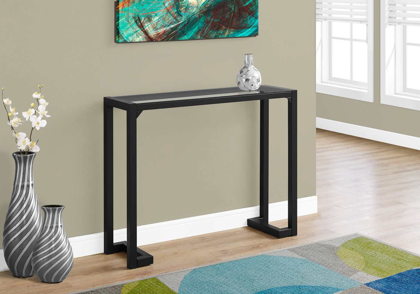 Sleek black metal frame console table with a glass top perfect for entryways