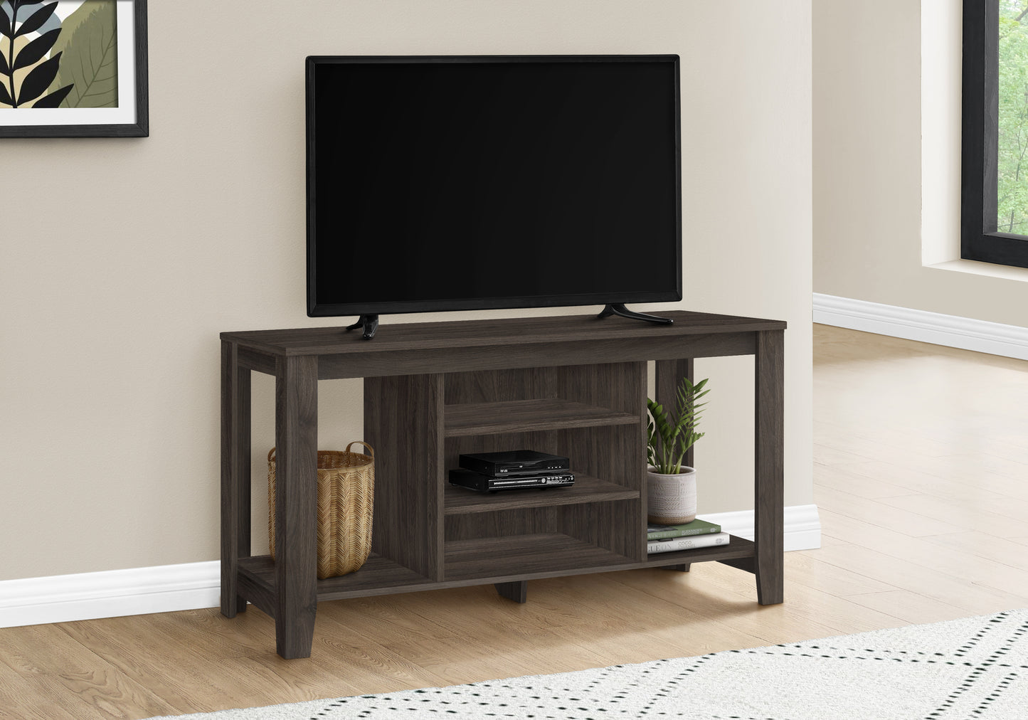 Dark wood TV stand with open shelving and a DVD player for modern living room entertainment