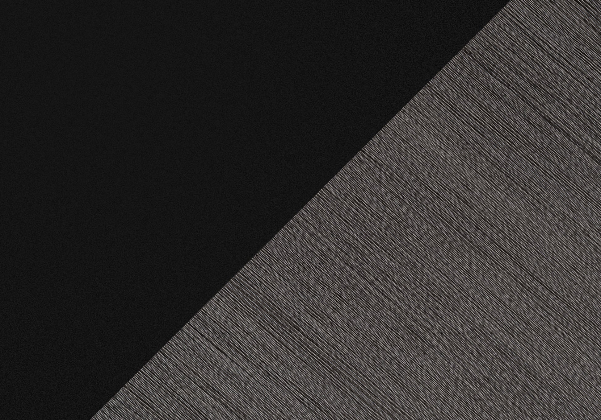 Matte black textured surface contrasting with fine grey linear pattern