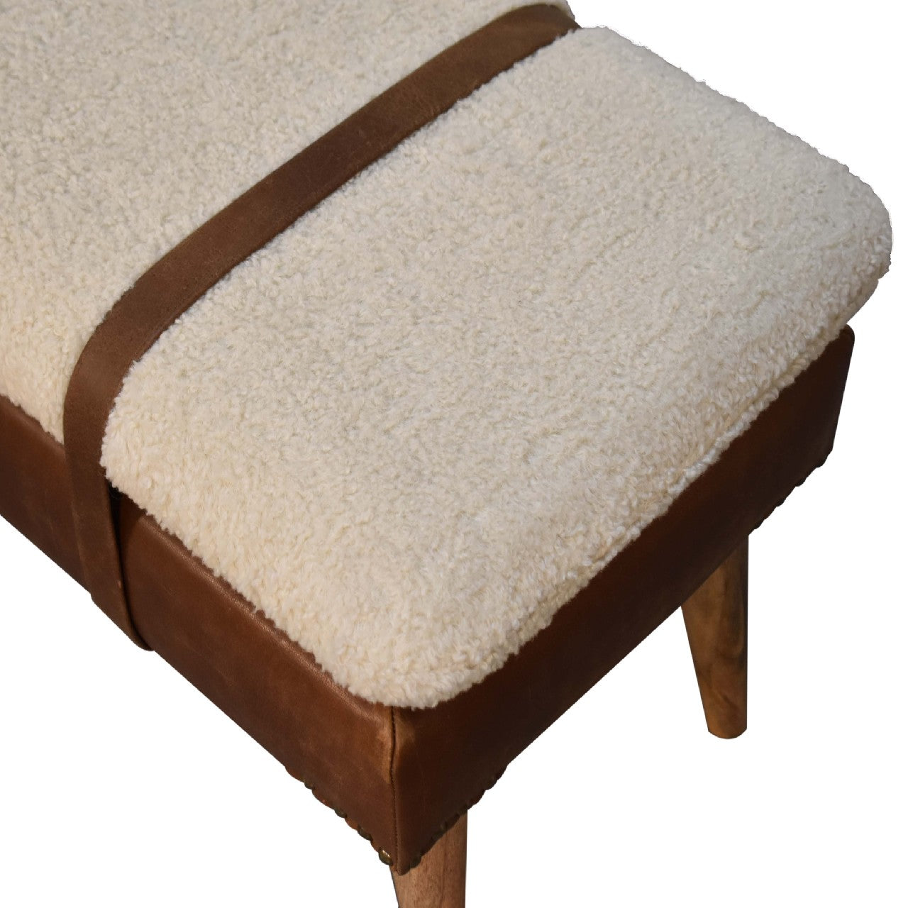 Creamy sherpa ottoman with brown leather accents and wooden legs