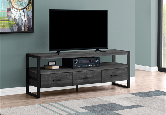 Gray wash wood TV stand with black metal frame and three drawers for media storage
