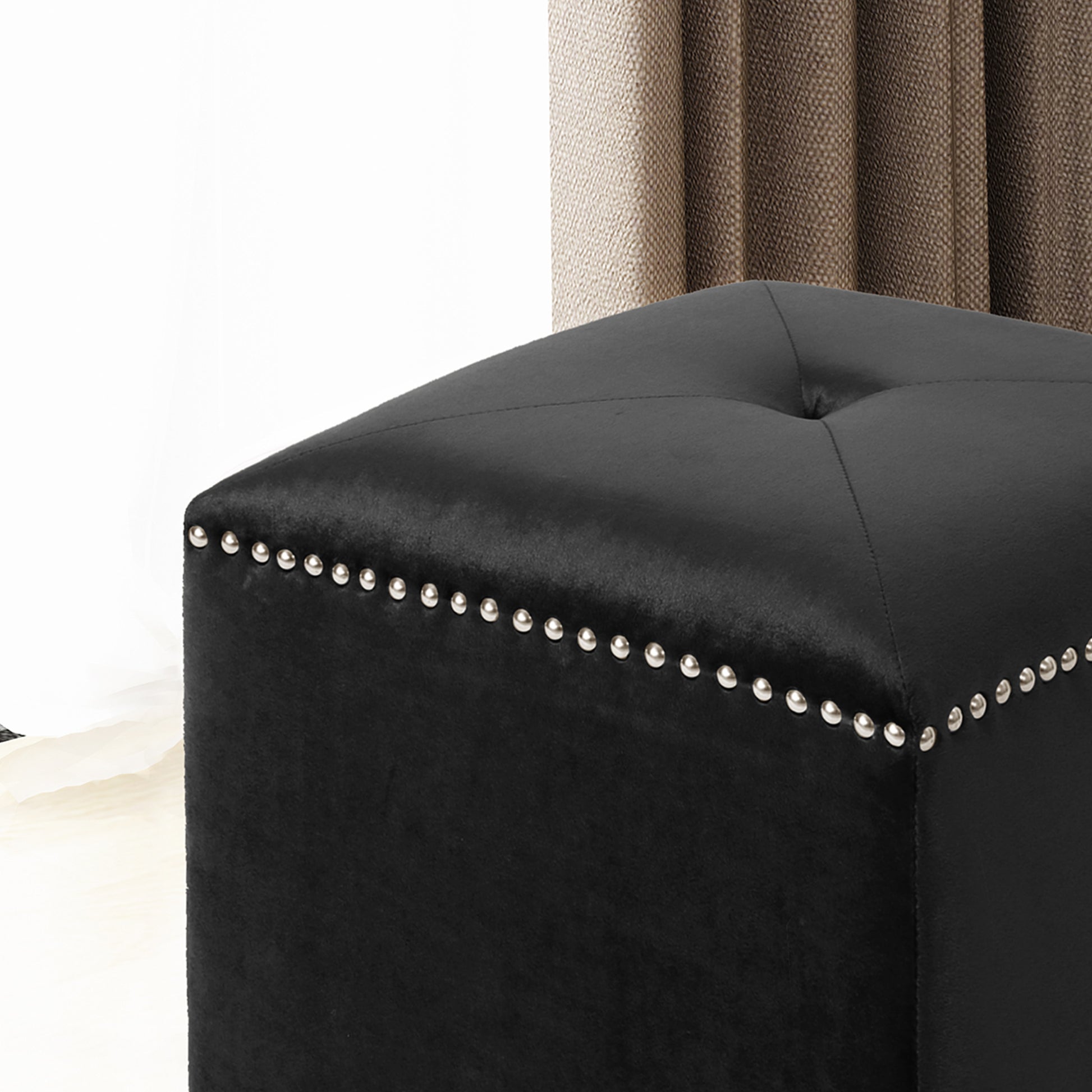 Black velvet square ottoman with silver nailhead trim and button tufting