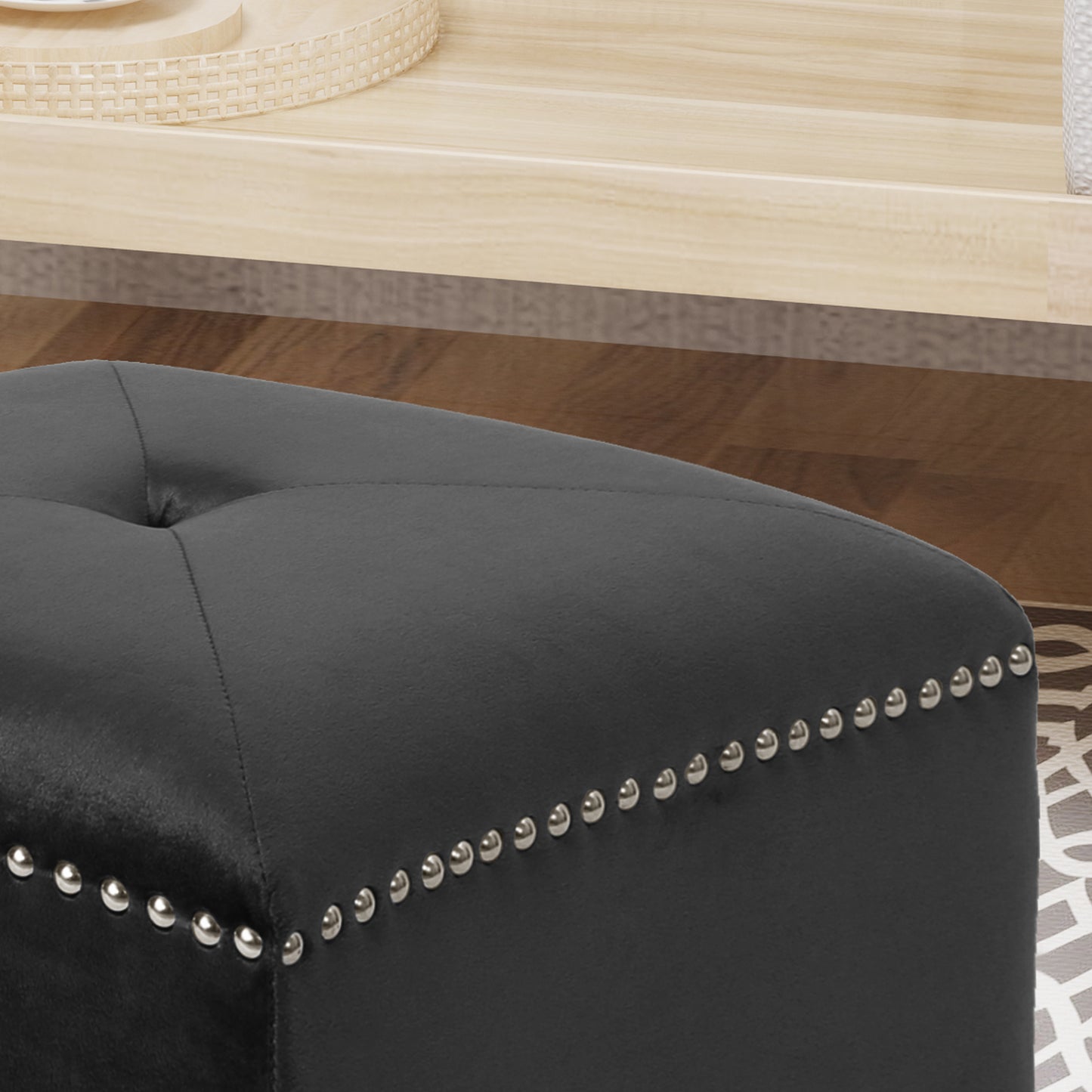 Black velvet tufted ottoman with silver nailhead trim