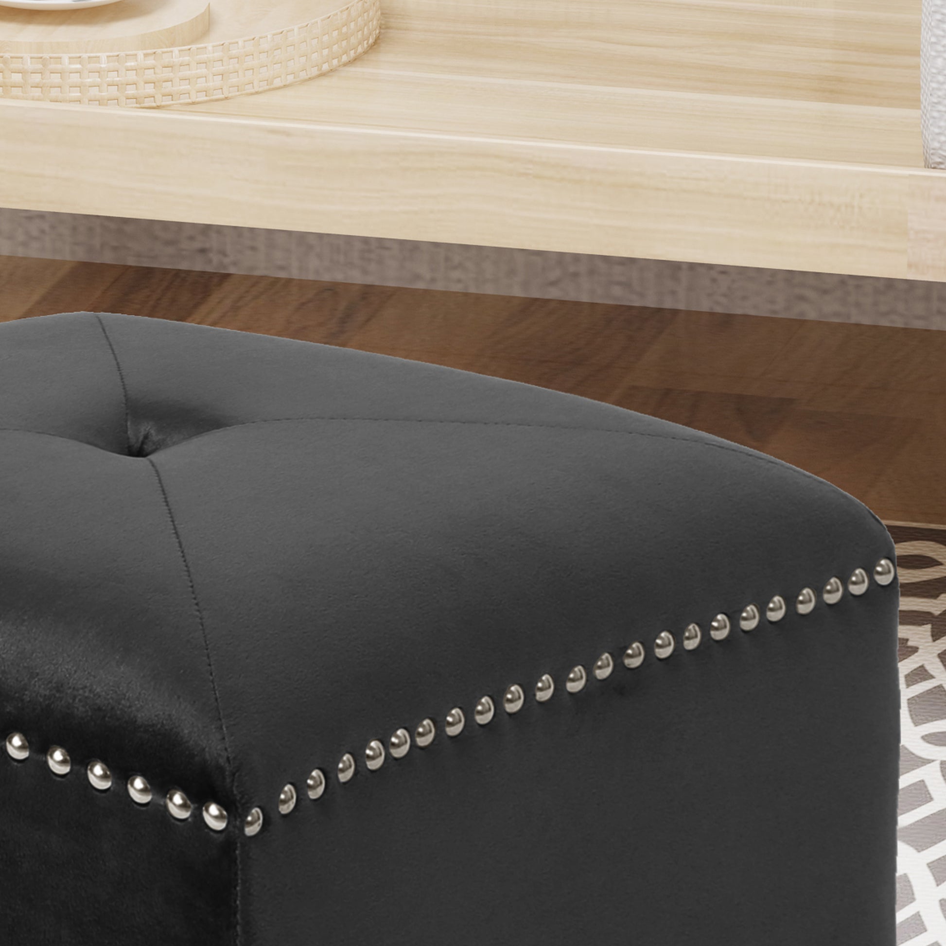 Black velvet tufted ottoman with silver nailhead trim