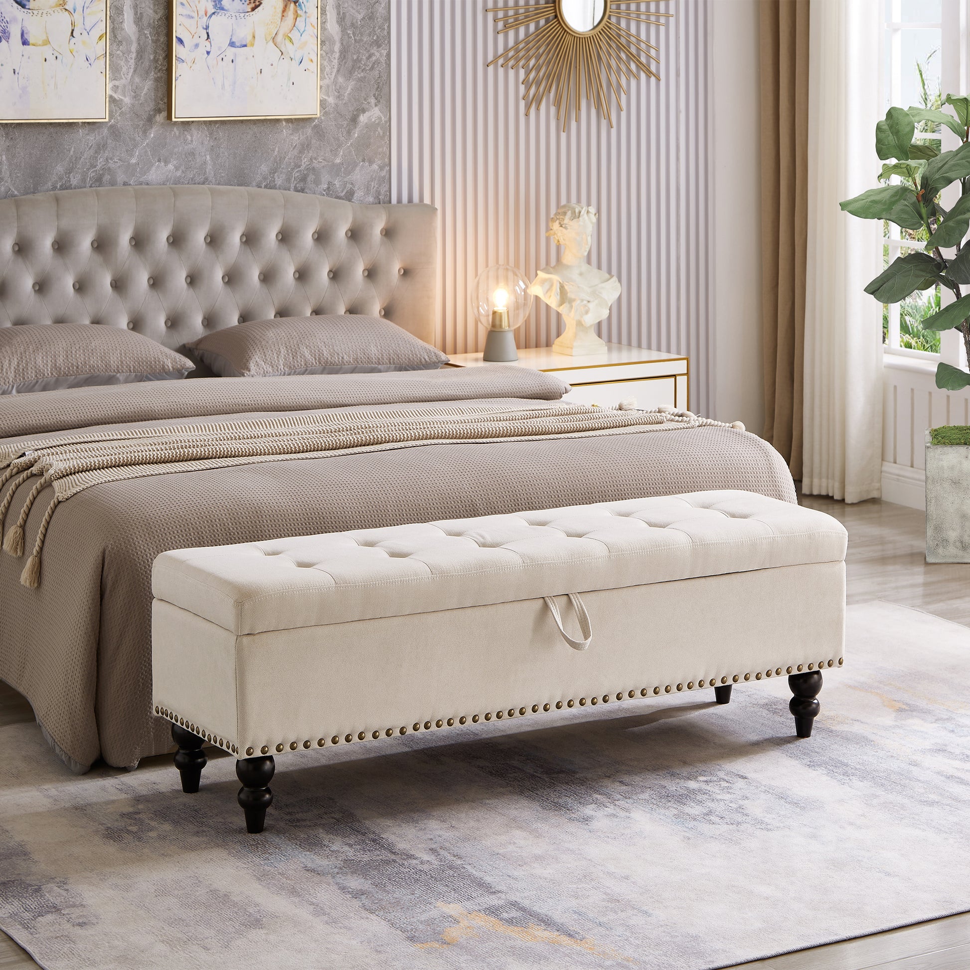 Tufted beige storage ottoman with nailhead trim and dark wooden legs
