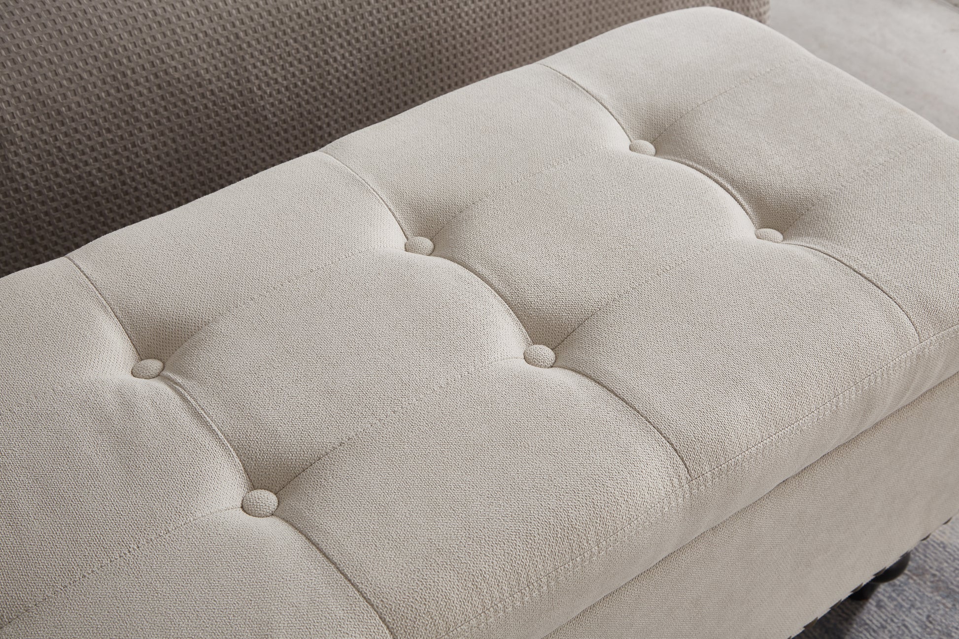 Cream tufted storage ottoman with textured fabric upholstery