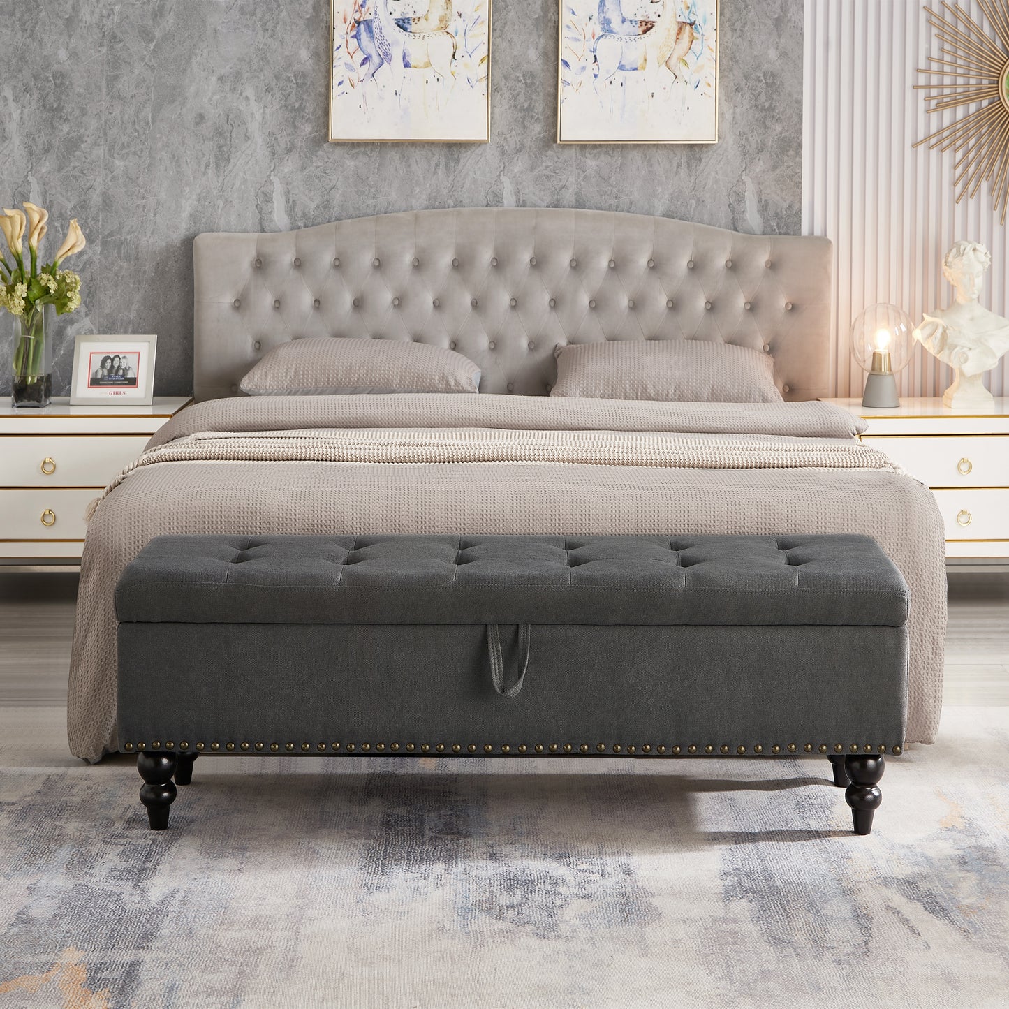 Dark grey tufted storage bench with brass nailhead trim