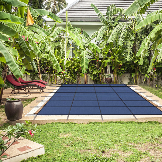 Durable blue solar pool cover with reinforced stitching secures a rectangular pool reducing evaporation