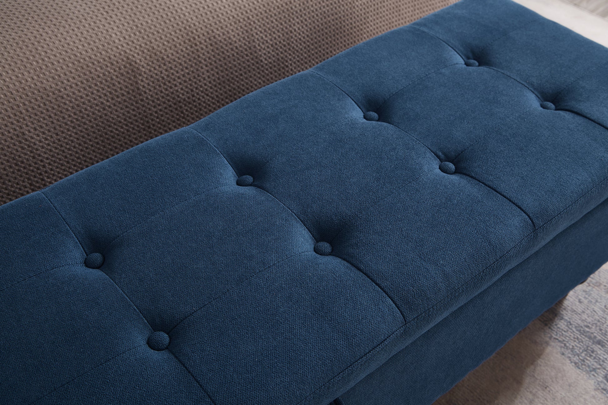 Deep navy storage ottoman with button tufting