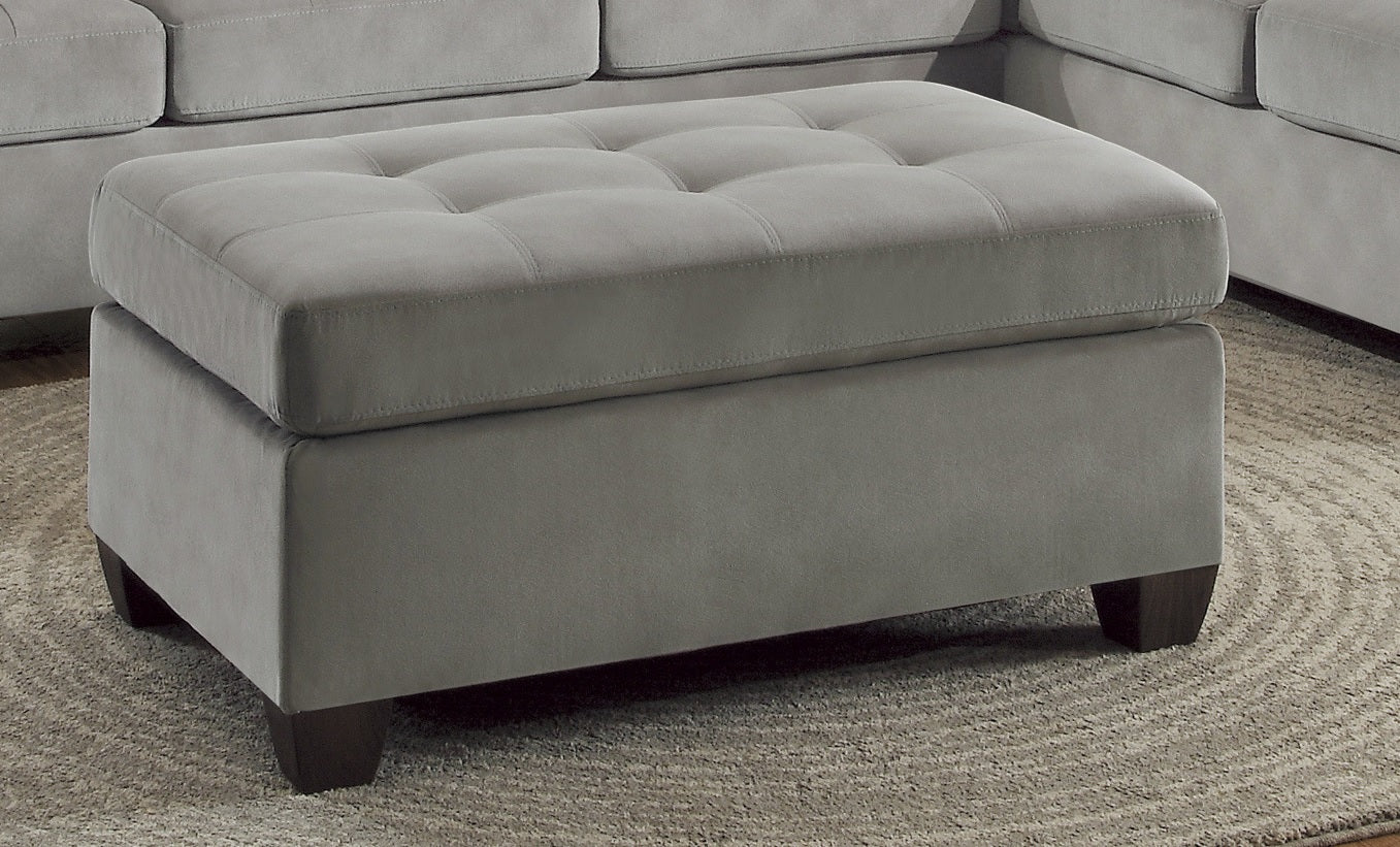 Tufted grey fabric ottoman with dark wooden legs ideal as a footrest or extra seating