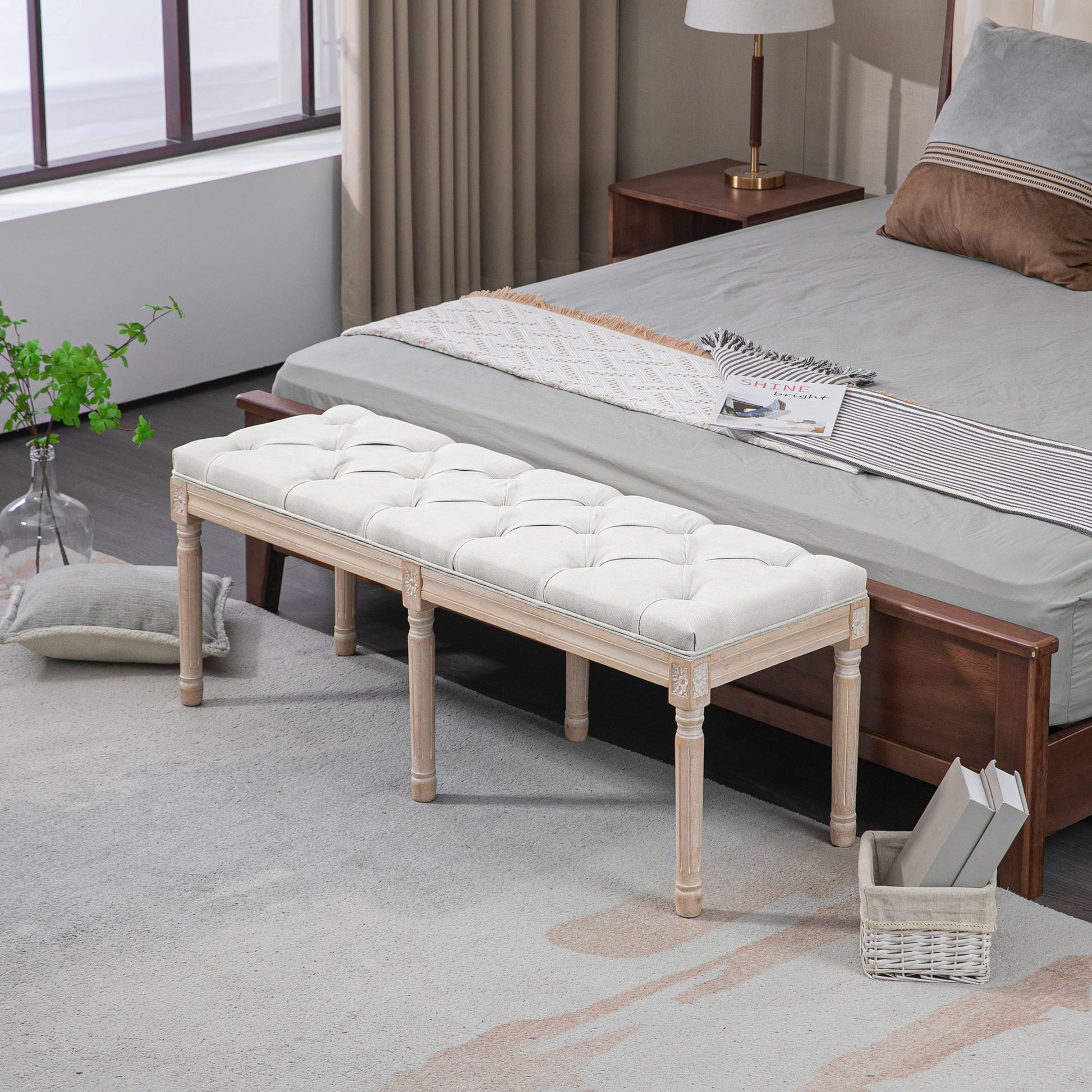White tufted bench with carved wooden legs