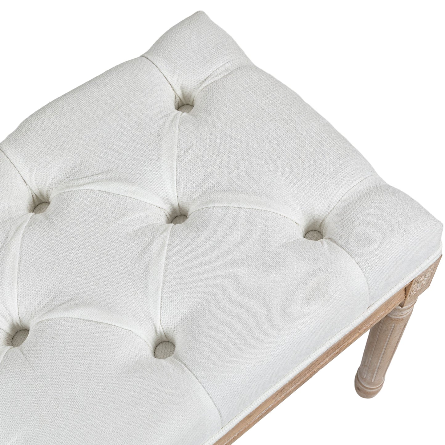 White tufted bench with light wood carved legs