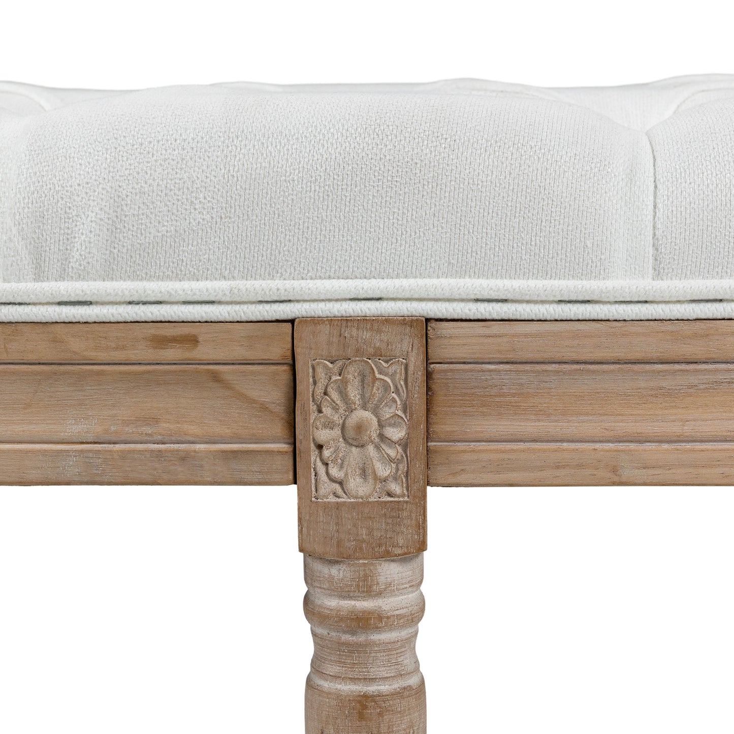 White tufted upholstered bench with carved wood accents