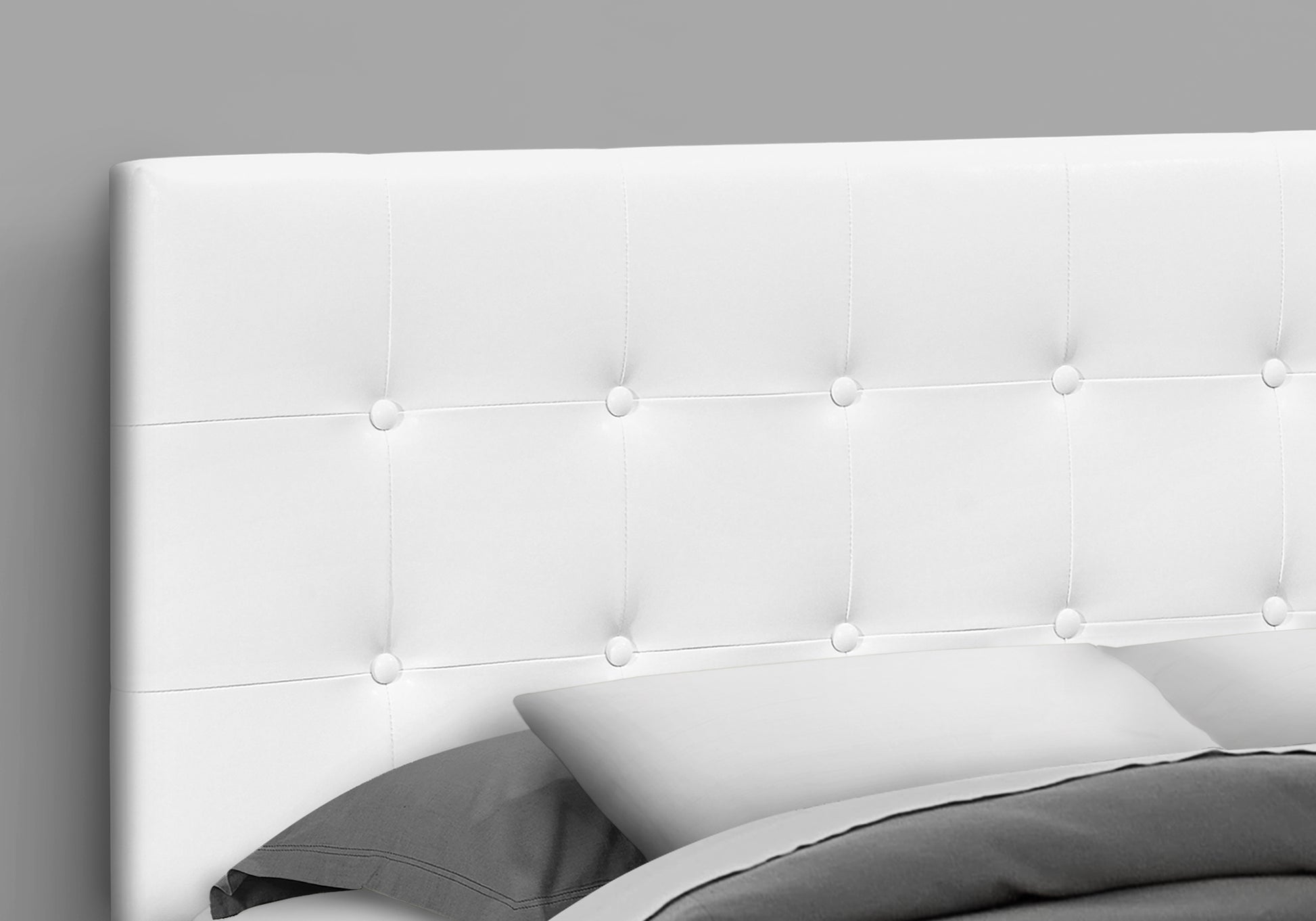 White faux leather tufted headboard with button details