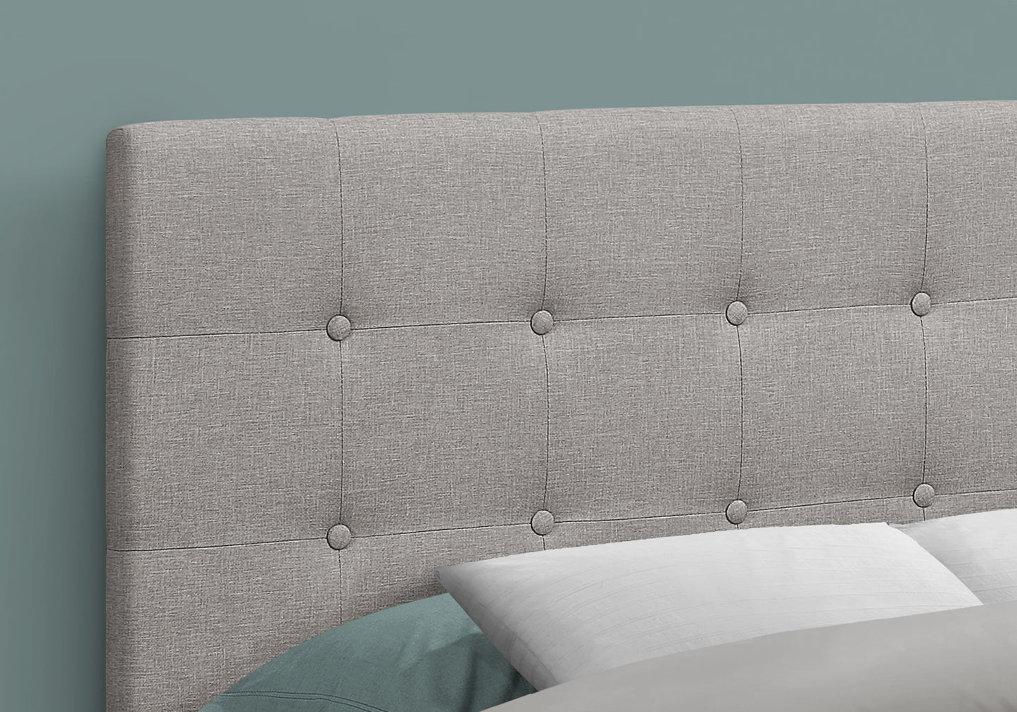 Grey upholstered headboard with button tufting for a modern bedroom