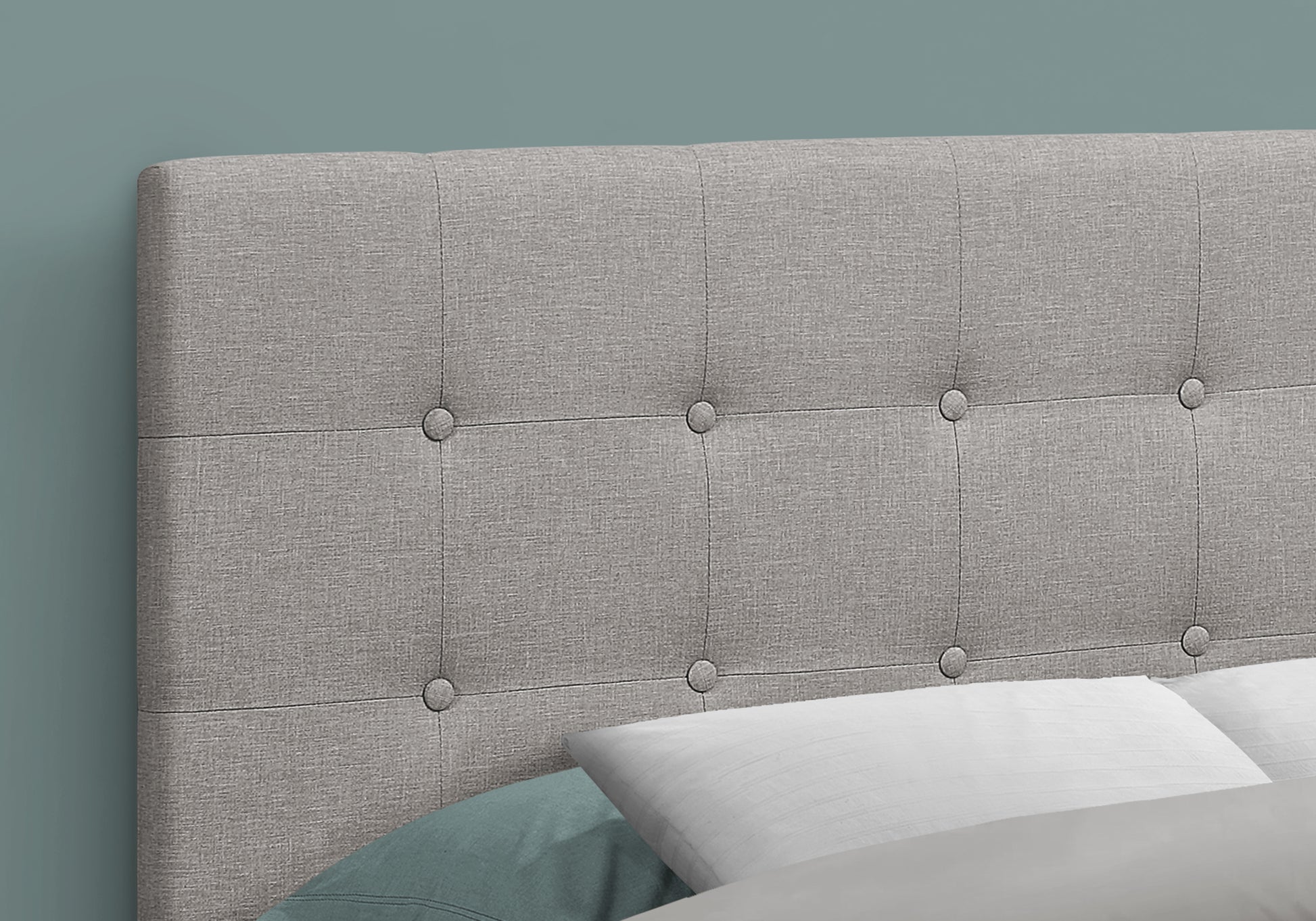 Grey upholstered headboard with button tufting for a modern bedroom