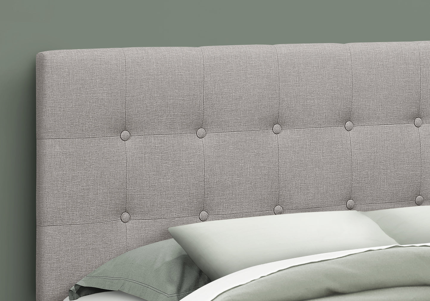 Grey upholstered headboard with button tufting for a modern bedroom