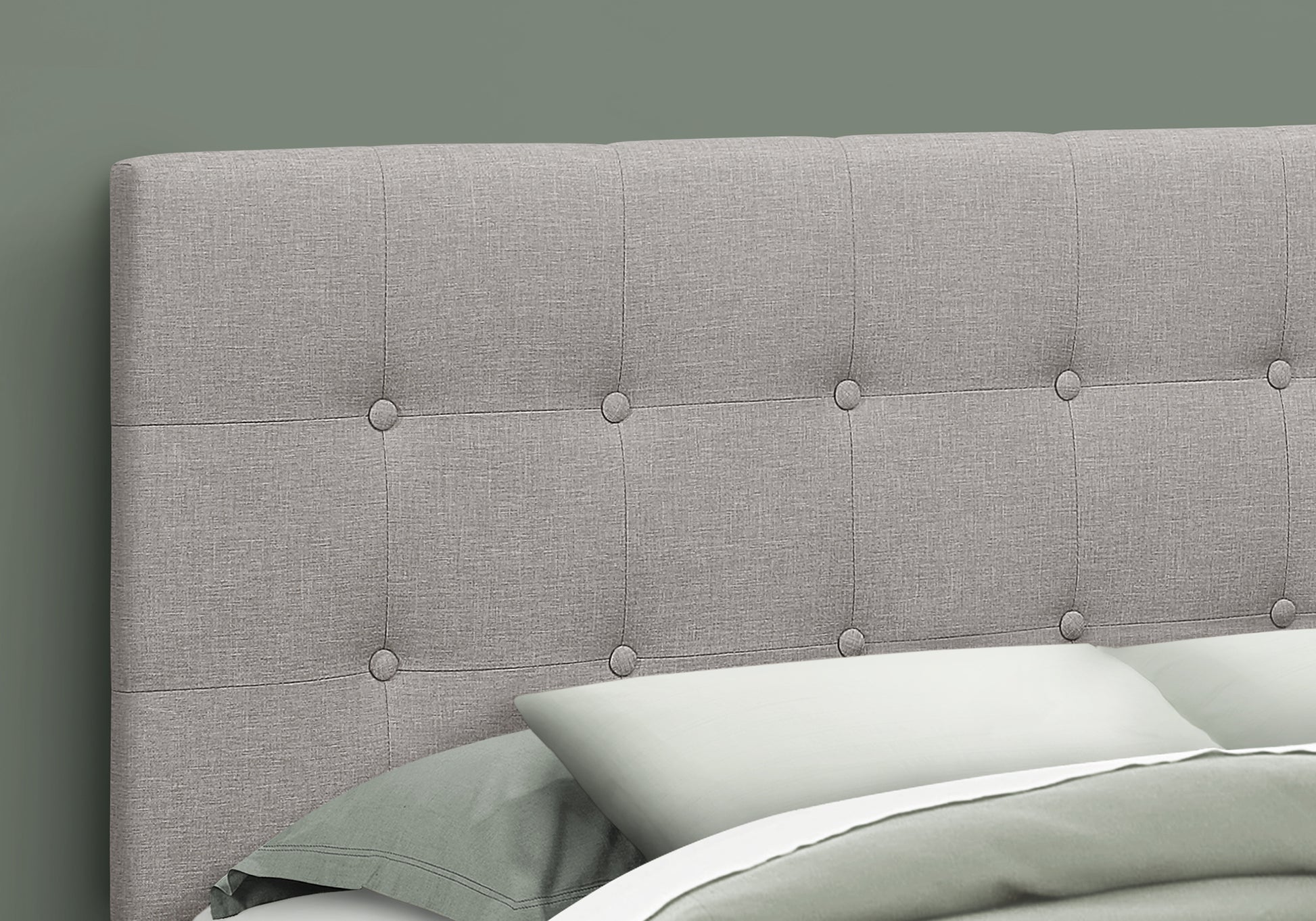 Grey upholstered headboard with button tufting for a modern bedroom