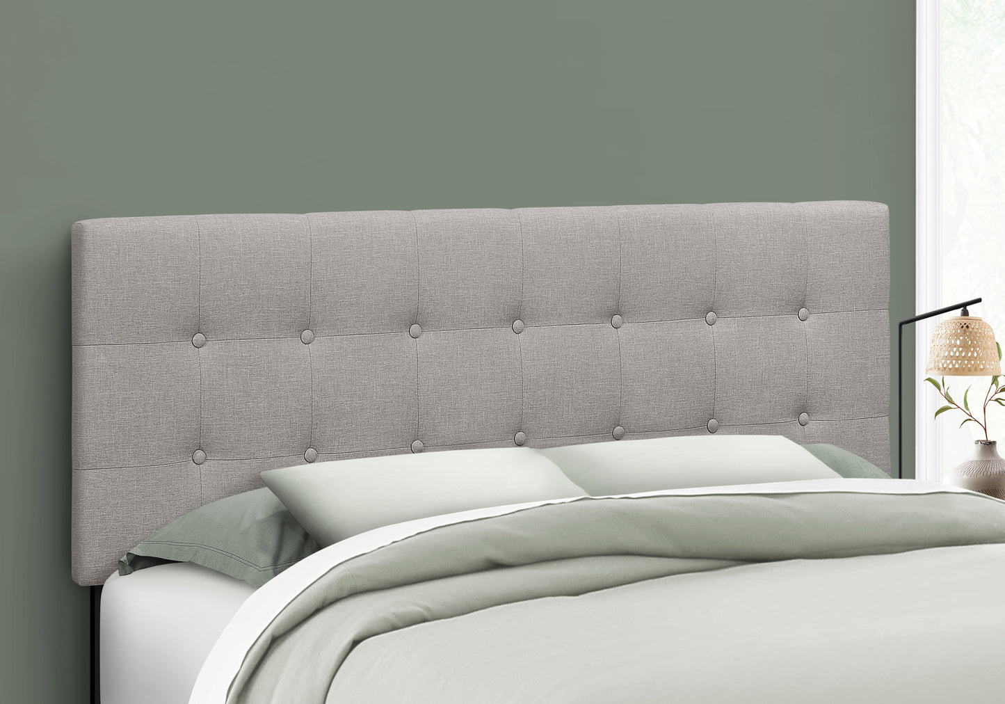Tufted grey fabric headboard with button accents a modern accent for any bedroom
