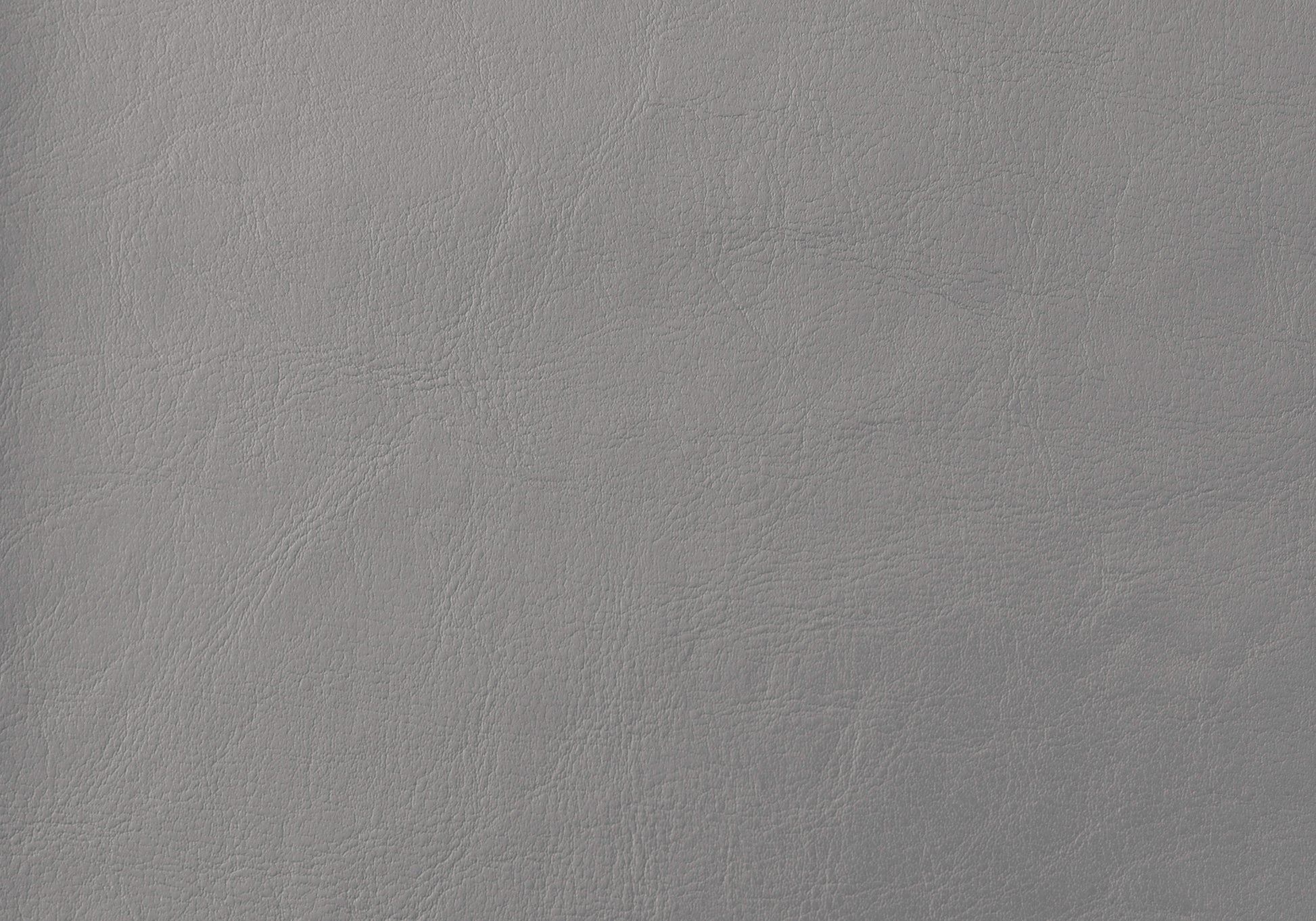 Closeup of textured grey vegan leather swatch with subtle grain for upholstery