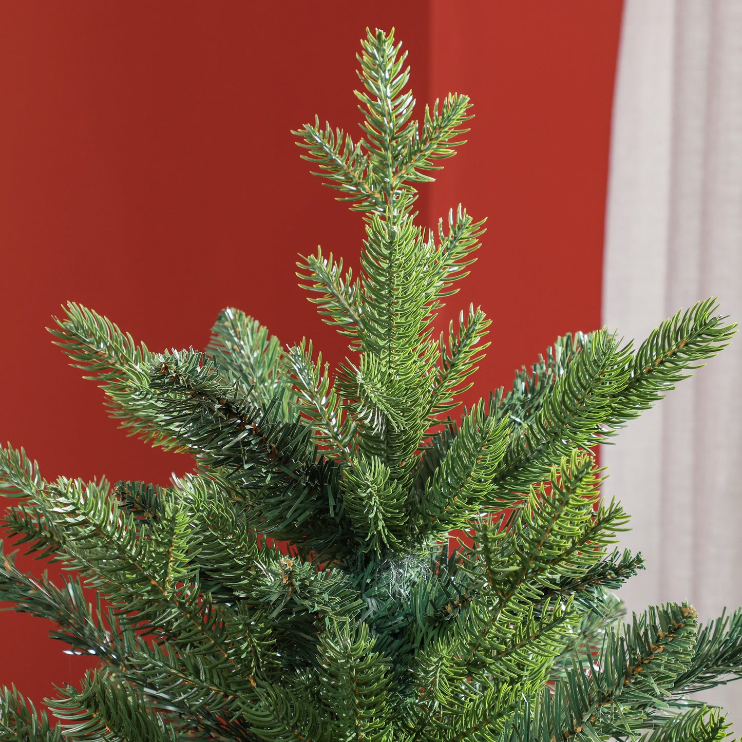 Closeup of a realistic artificial Christmas trees dense green pine needles perfect for festive decor