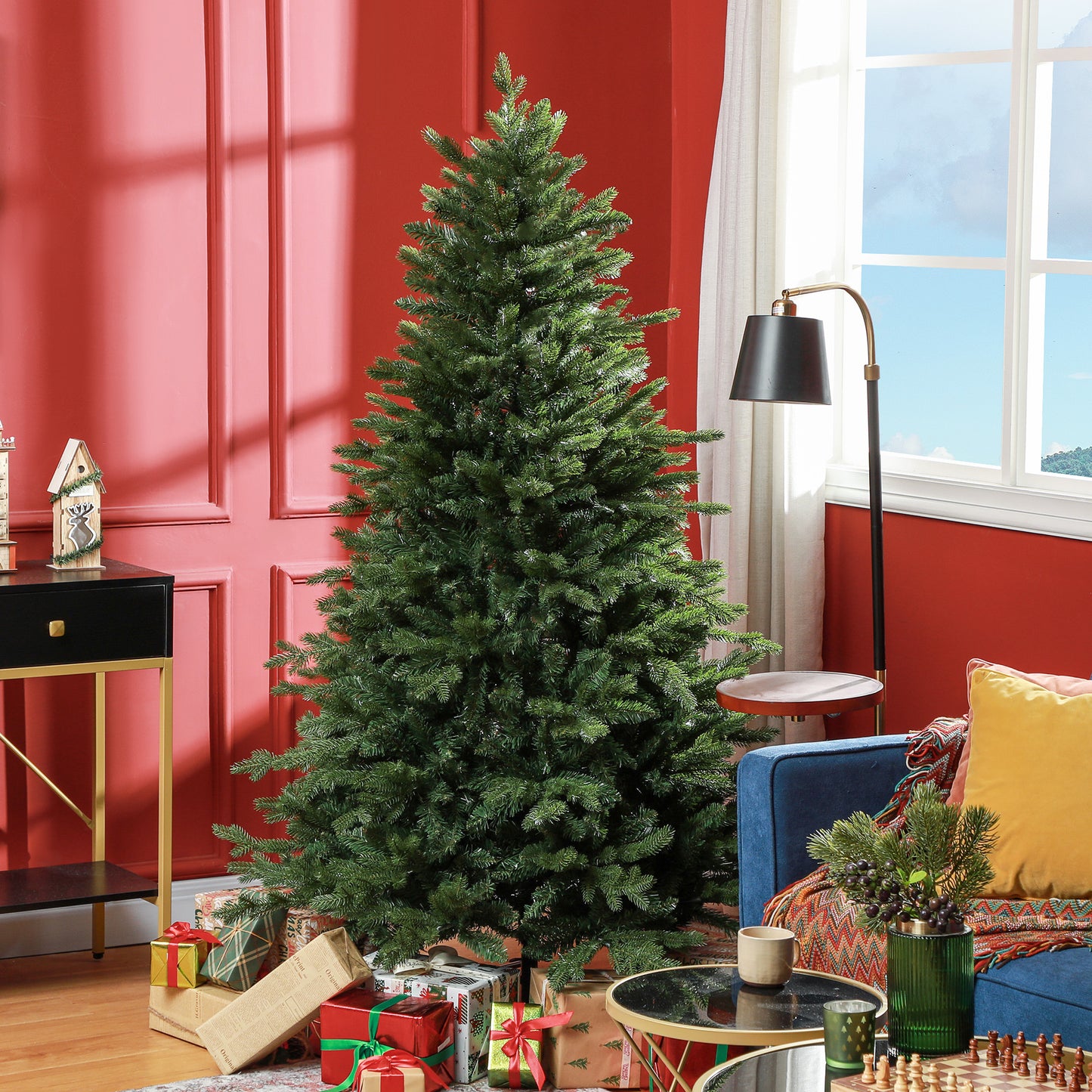 Full lush green artificial christmas tree with wrapped gifts at its base